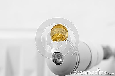 European coin on the thermostat of a hot central heating radiator Stock Photo