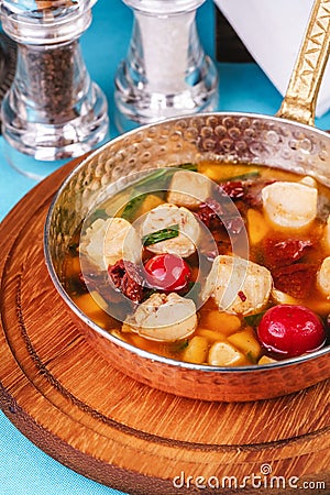 Italian fish soup with tomatoes, dough, dumplings, potatoes and greens. Mediterranean cuisine, European dish Stock Photo