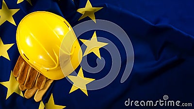 European employment in construction heavy industry, Labour day and industrial work concept with close up on a yellow hard hat and Stock Photo