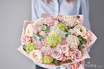 European floral shop. Beautiful bouquet of mixed flowers in womans hands. the work of the florist at a flower shop Stock Photo