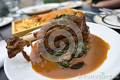 European Food: Roasted lamb shank in gravy sauce Stock Photo