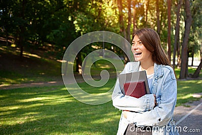 European happy freelancer girl holding notepad and laptop Stock Photo