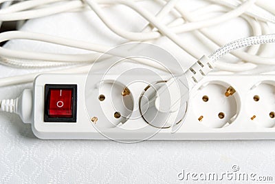 European household white extension cord for 220v with fuse on white textile Stock Photo