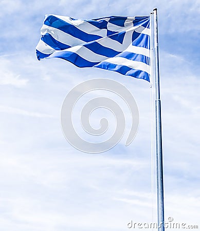 Greek flag and cloudy sky in summer day, politics of Europe Stock Photo