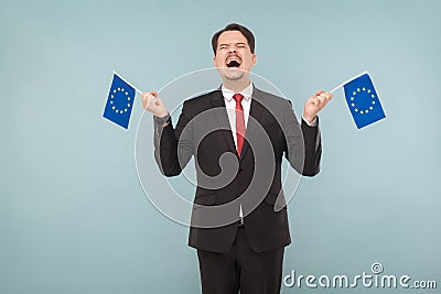European politician holds flags and rejoices Stock Photo