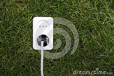 European power socket on grass. Energy concept Stock Photo
