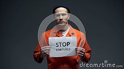 European prisoner holding stop tortures sign, physical abuse in cell, harassment Stock Photo