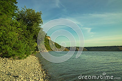 European spring time landscape of forest edge green foliage and stone waterfront of calm lake peaceful waters , copy space Stock Photo