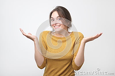 European student woman in gesture of asking over gray background Stock Photo