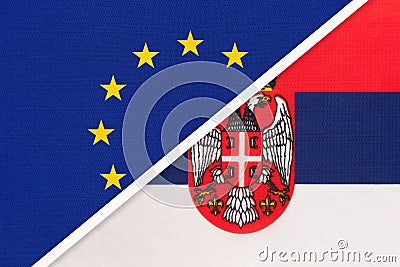 European Union or EU vs Serbia national flag from textile. Symbol of the Council of Europe association Stock Photo