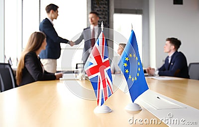 European Union and United Kingdom leaders shaking hands on a deal agreement. Brexit. Stock Photo