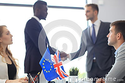 European Union and United Kingdom leaders shaking hands on a deal agreement. Brexit. Stock Photo