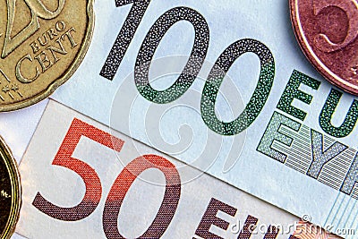 50 and 100 euros close-up. Euro cents are located on the sides. investment concept Stock Photo