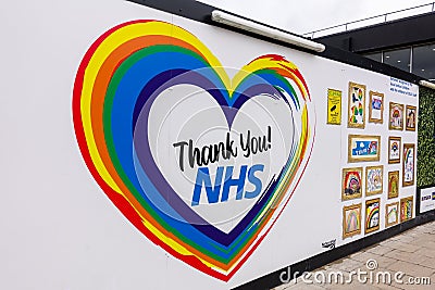 At Euston station, a large poster banner wall with Thank you NHS and rainbow heart. Editorial Stock Photo