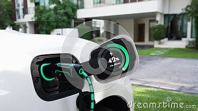 EV charger from home charging station recharging electric car. Peruse Stock Photo