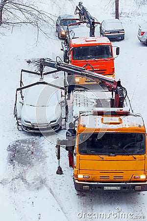 Evacuation of incorrectly parked cars on a winter day. Editorial Stock Photo