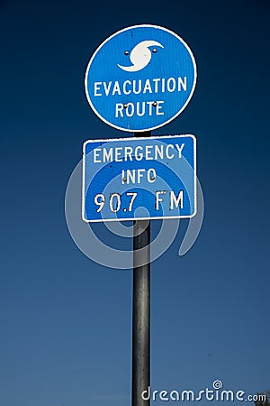 Evacuation route highway sign and blue skies Stock Photo