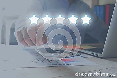 Evaluation concept. Businessman pointing five star to increase rating of company. Stock Photo