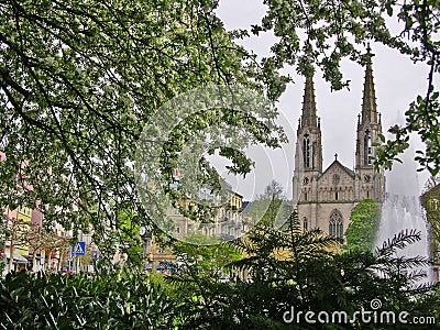 Protestant town church on Augustaplatz in Baden-Baden with branches and flowers in the foreground Stock Photo