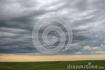 Evening clouds above the ground Stock Photo