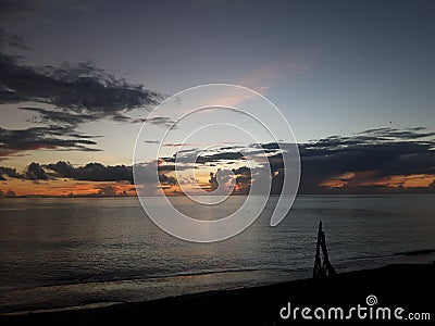 Evening colours dashes of black clouds with fiery orange sun rays Stock Photo