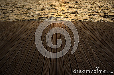 Evening deck waterfront floor background perspective surface along sea water with small waves Stock Photo