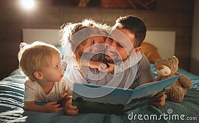 evening family reading. father reads children . book before going to bed . Stock Photo