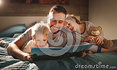 Evening family reading. father reads children . book before goin Stock Photo