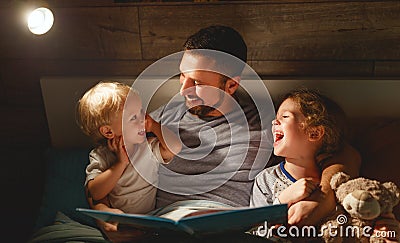 evening family reading. father reads children . book before going to bed Stock Photo
