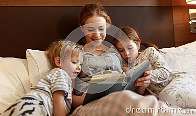 Evening family reading. mother reads children . book before going to bed Stock Photo