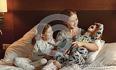 Evening family reading. mother reads children . book before going to bed Stock Photo