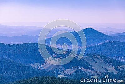 Evening haze over forested hills and mountains. Stock Photo