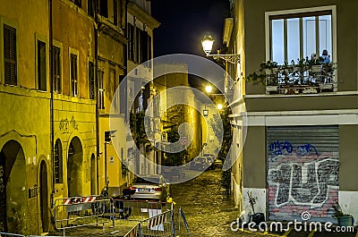 Evening narrow streets of old Rome, Italy Night with parked cars on them and glowing lanterns and houses with windows that light Editorial Stock Photo