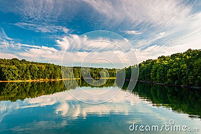 Evening reflections of clouds and trees in Lake Marburg, Codorus State Park, Pennsylvania. Stock Photo