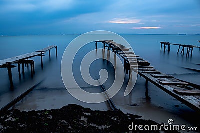 Three old woodern bridges leading into the open sea Stock Photo