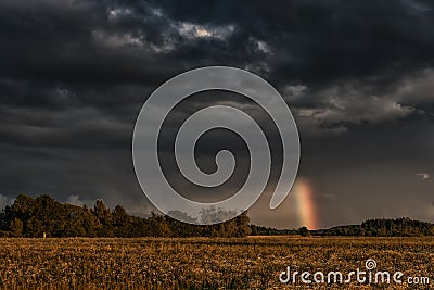 Evening Stormy Cloudy Blue Gray Sky. Use it As a Background. Rainbow in Background. Stock Photo
