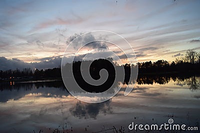 Evening Sunlight Reflects On Lake Water Stock Photo