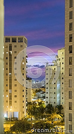 Evening sunset in a large modern city with tall houses Stock Photo