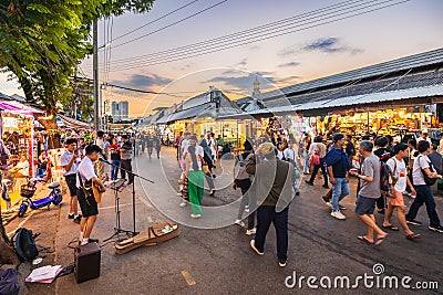 Evening time At Chatuchak Market, witness young performers and street musicians showcasing diverse talents through busking and Editorial Stock Photo