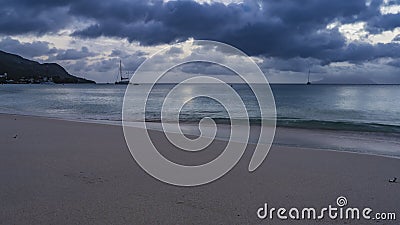 Evening on a tropical beach. Dark blue clouds in the sky. Stock Photo