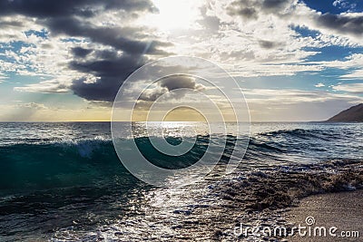 Evening view with sun shining throug clouds at Makua beach, Oahu Stock Photo