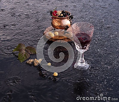 Evening wine on the veranda on a hot day in the rain Stock Photo