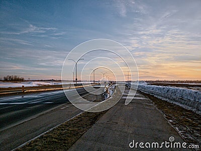 Evening winter road with colorful sky Stock Photo