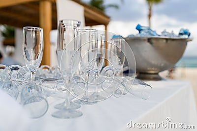 Empty glasses before reception with cooler in the background Stock Photo