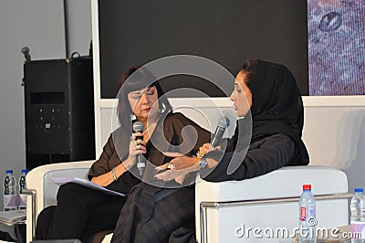 Event moderator interviewing Arabic Designer - Black and white stage and clothing Editorial Stock Photo