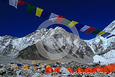 Everest climbers` tents on Khumbu glacier with prayer flags Stock Photo