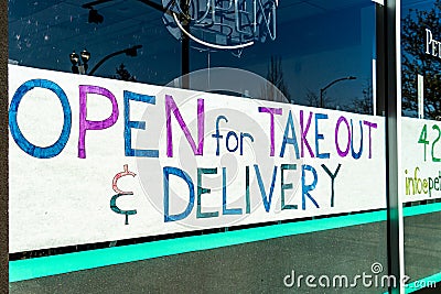Closed Downtown Business signs advertising grab and go take out food due to state mandated Editorial Stock Photo