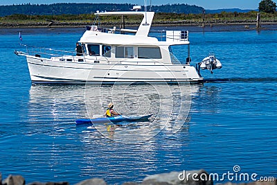 Pleasure Craft Boat and Kyak in Port Gardner on a sunny summer day Editorial Stock Photo