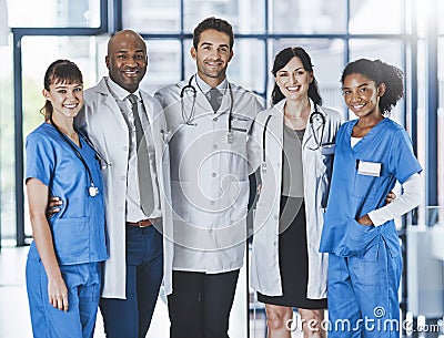 Everyday were doctoring. Portrait of a diverse team of doctors standing together in a hospital. Stock Photo