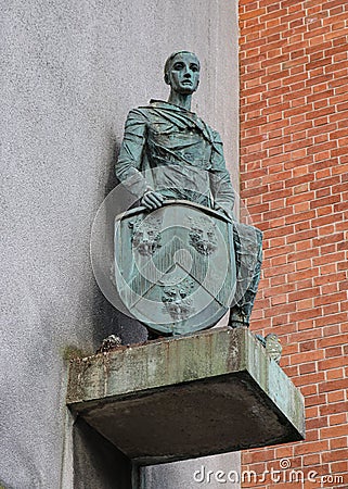 Everyman Bronze statue of a young man in medieval dress supporting the shield of the former Stratford Borough Editorial Stock Photo